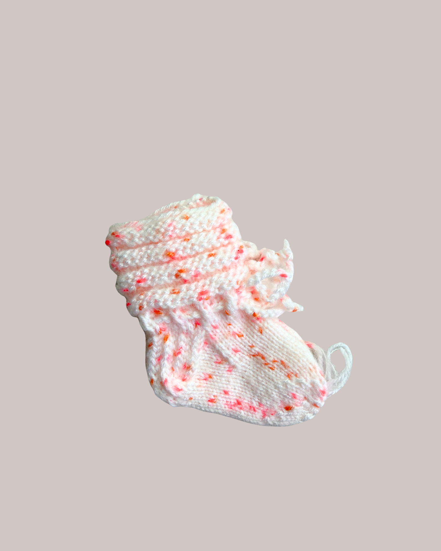 Hand knitted white baby booties with pink and orange speckled yarn for newborns