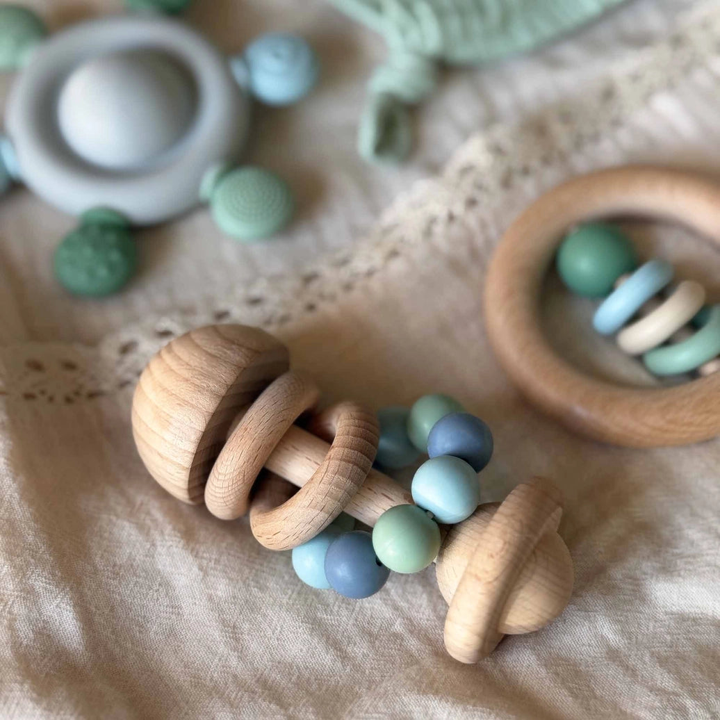 Blue silicone bead baby rattle made from natural wood for sensory play and teething