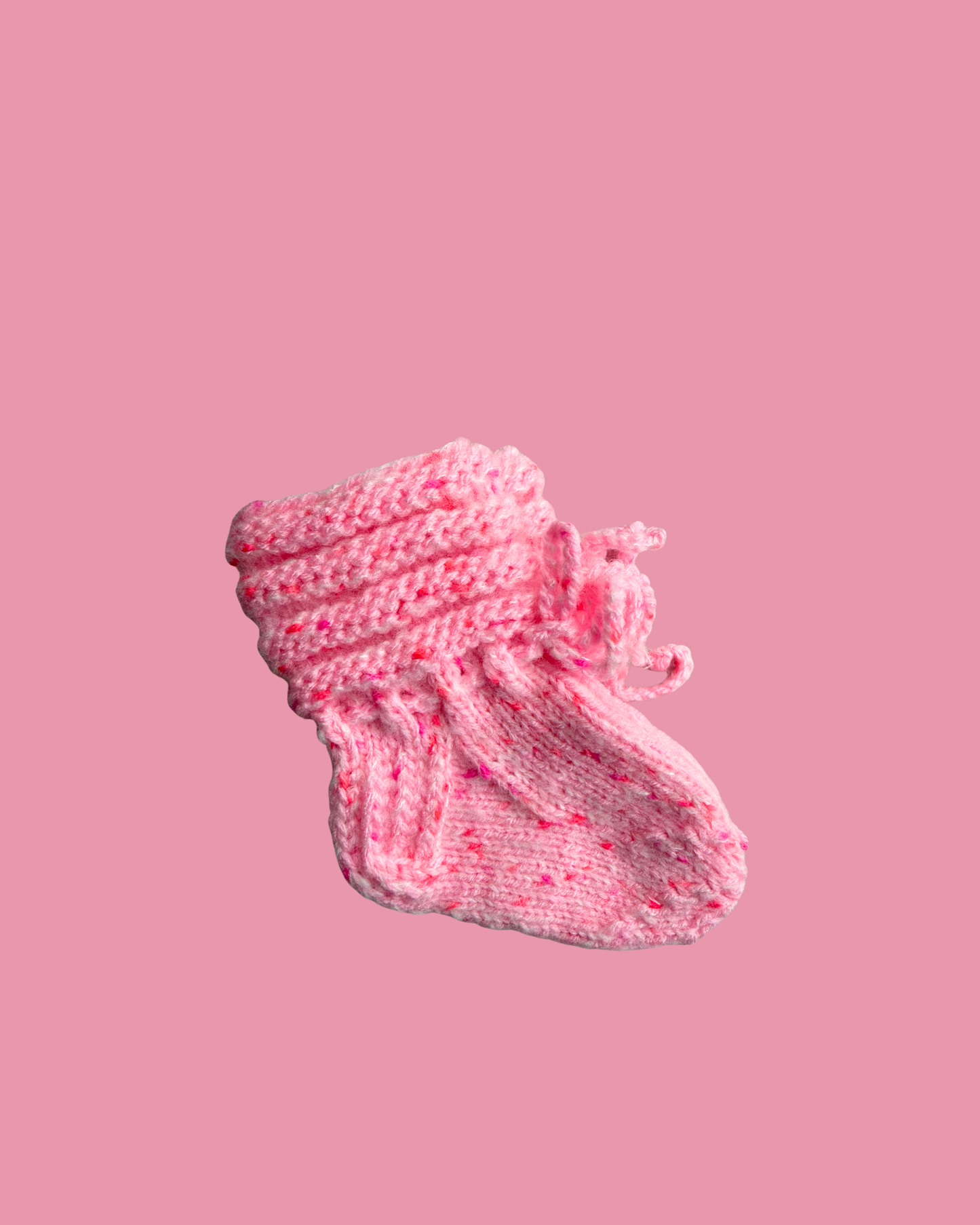 Hand knitted pink baby booties with soft speckled yarn for newborns