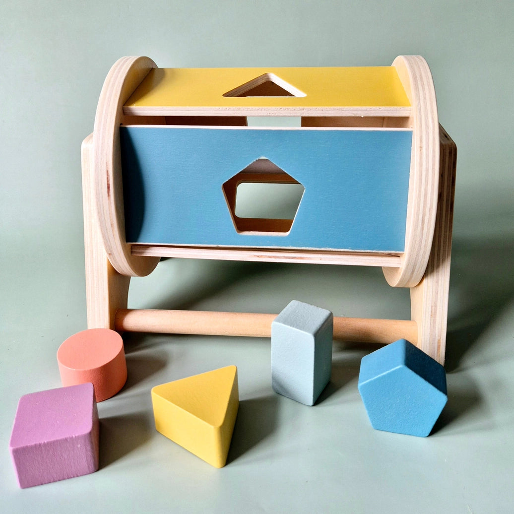 Rotating wooden shape sorter toy for children developing hand eye coordination and problem solving